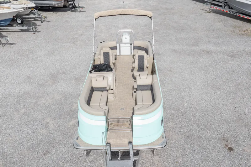 Slide: The Image of 2024 SilverWave 2210 CLS SW5 pontoon boat on trailer, beige seating, teal accents. - 37