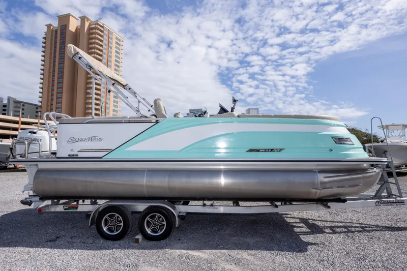 Slide: The Image of 2024 SilverWave 2210 CLS SW5 pontoon boat with Suzuki engine on trailer. - 4