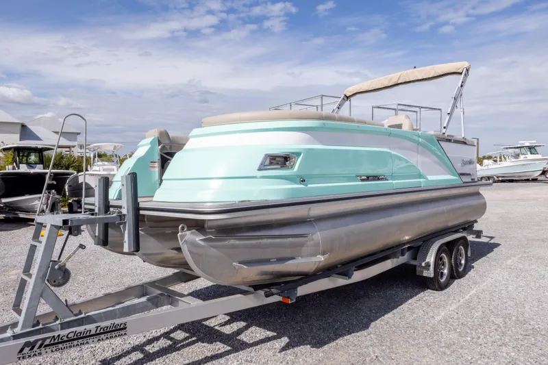 Slide: The Image of 2024 SilverWave 2210 CLS SW5 pontoon boat on trailer, featuring sleek design and modern amenities. - 9