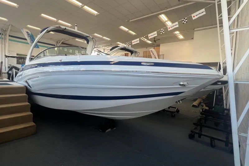 The Image of 2024 Crownline Eclipse E280 XS boat displayed indoors, showcasing sleek design and modern features. - 0