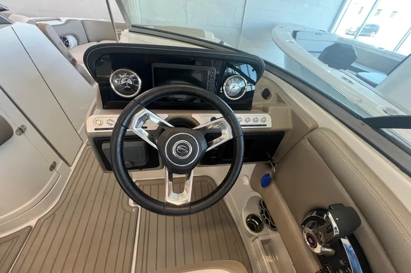 Slide: The Image of 2024 Crownline Eclipse E280 XS boat dashboard with steering wheel and controls. - 10