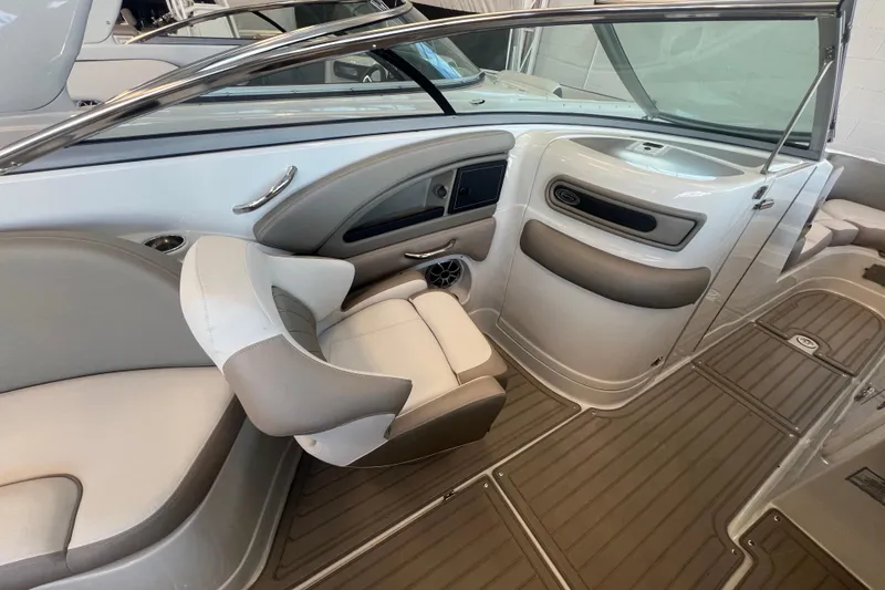 Slide: The Image of 2024 Crownline Eclipse E280 XS boat interior with sleek seating and modern dashboard design. - 11