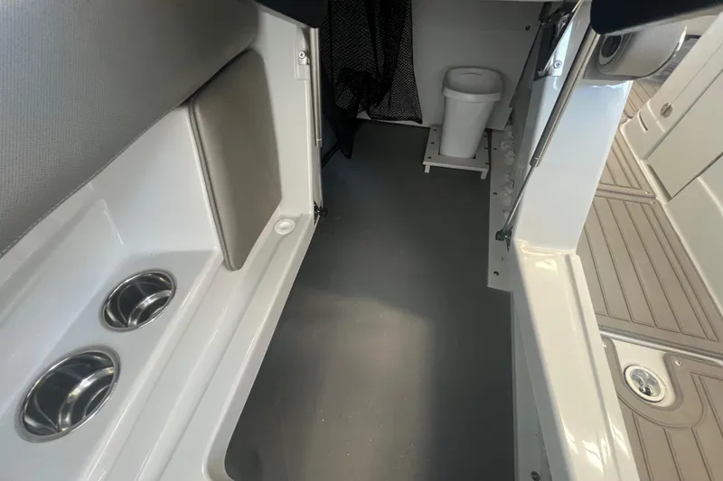 Slide: The Image of 2024 Crownline Eclipse E280 XS interior with cup holders and sleek design. - 14