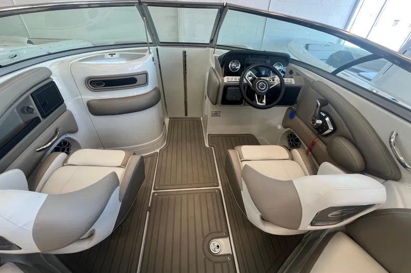 Slide: The Image of Interior of 2024 Crownline Eclipse E280 XS boat, featuring modern seating and steering console. - 15