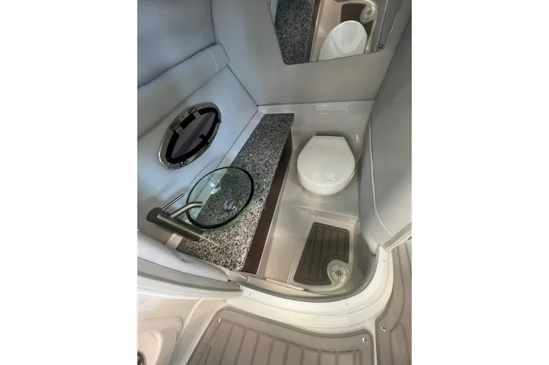Slide: The Image of 2024 Crownline Eclipse E280 XS boat bathroom with modern sink and toilet. - 16