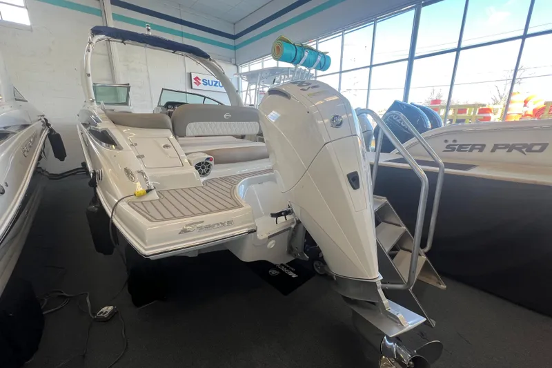 Slide: The Image of 2024 Crownline Eclipse E280 XS boat with outboard motor in showroom. - 5