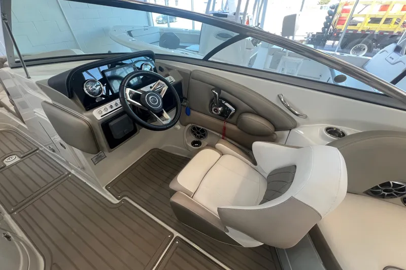 Slide: The Image of 2024 Crownline Eclipse E280 XS boat interior with modern steering and dashboard controls. - 9