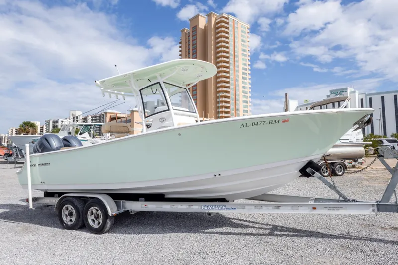 Slide: The Image of 2019 Sportsman Heritage 251 Center Console boat on trailer, urban backdrop. - 11