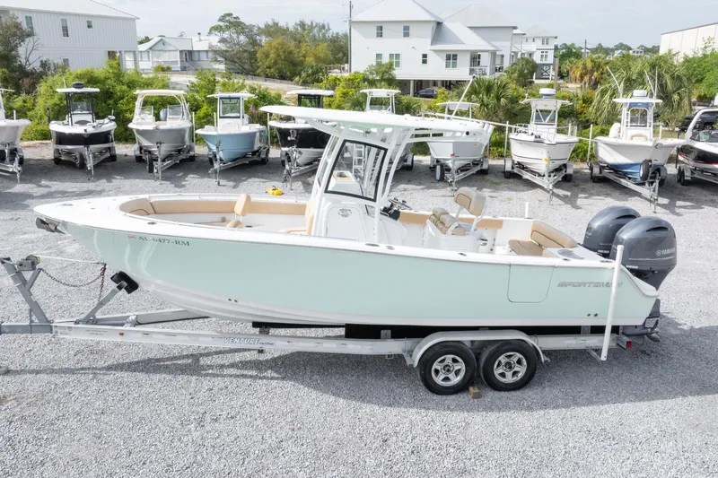 Slide: The Image of 2019 Sportsman Heritage 251 Center Console boat on trailer, surrounded by other boats. - 12