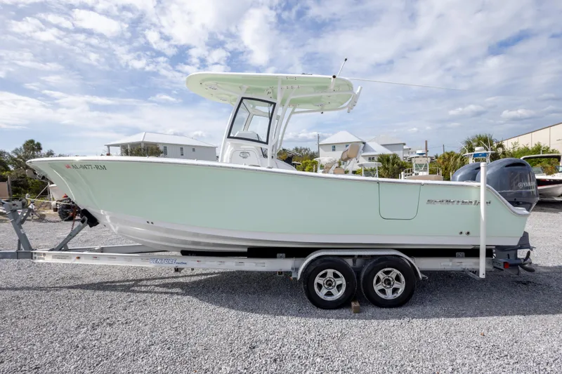 Slide: The Image of 2019 Sportsman Heritage 251 Center Console boat on trailer, parked outdoors. - 13