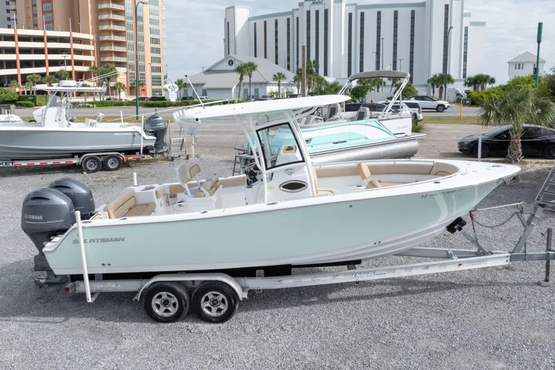 Slide: The Image of 2019 Sportsman Heritage 251 Center Console boat on trailer, parked outdoors. - 17