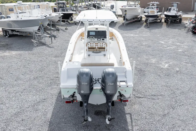 Slide: The Image of 2019 Sportsman Heritage 251 Center Console boat with dual outboard engines in a marina. - 19