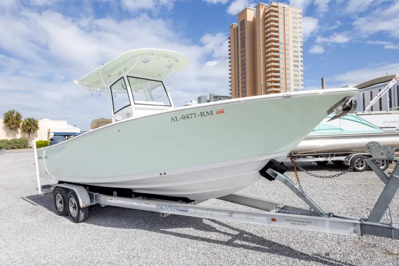Slide: The Image of 2019 Sportsman Heritage 251 Center Console boat on trailer, urban backdrop. - 20