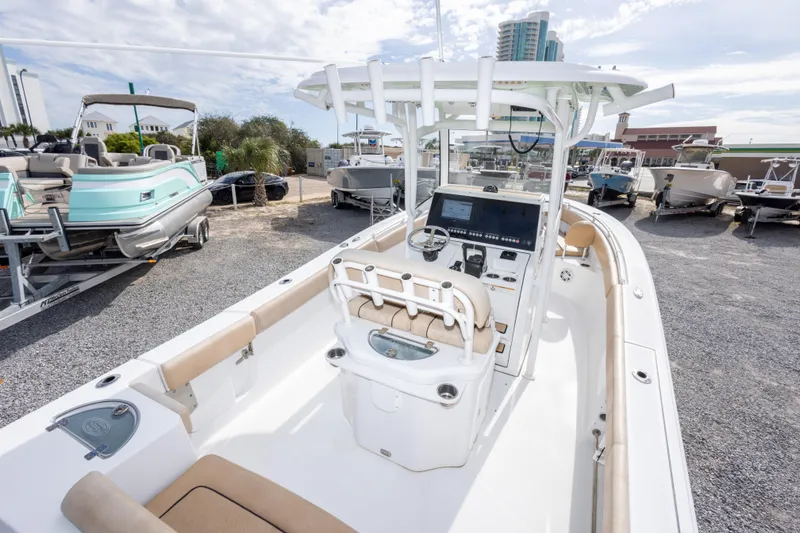 Slide: The Image of 2019 Sportsman Heritage 251 Center Console boat in a marina, showcasing helm and seating area. - 24