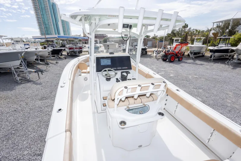 Slide: The Image of 2019 Sportsman Heritage 251 Center Console boat in a marina with other vessels. - 25
