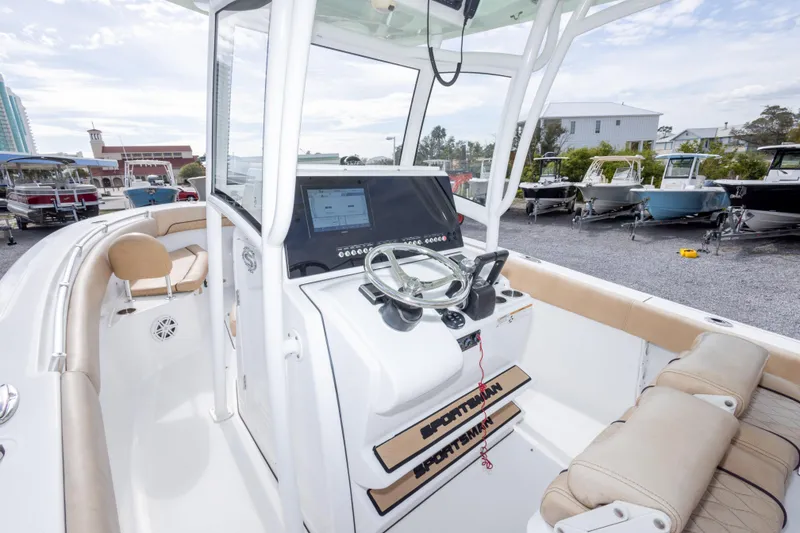 Slide: The Image of 2019 Sportsman Heritage 251 Center Console boat with modern helm and seating in a marina. - 29