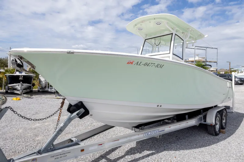 Slide: The Image of 2019 Sportsman Heritage 251 Center Console boat on trailer, parked outdoors. - 3
