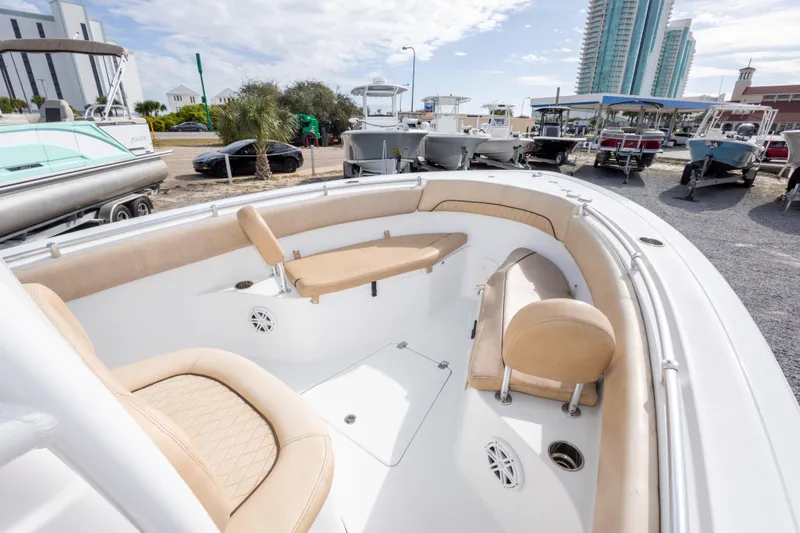 Slide: The Image of 2019 Sportsman Heritage 251 Center Console boat with beige seating, docked outdoors. - 33