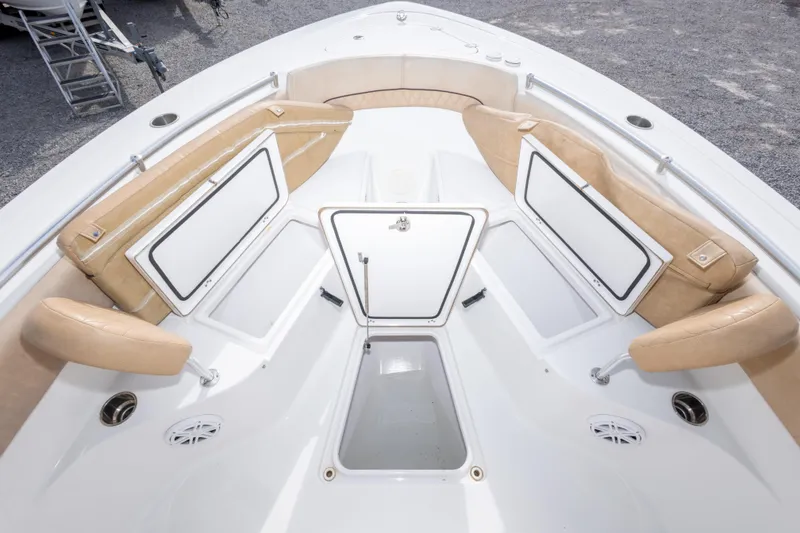 Slide: The Image of 2019 Sportsman Heritage 251 Center Console boat interior with tan seating and storage compartments. - 38