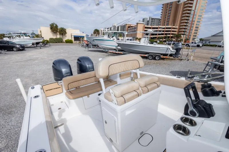Slide: The Image of 2019 Sportsman Heritage 251 Center Console boat with dual engines, parked in a marina. - 39