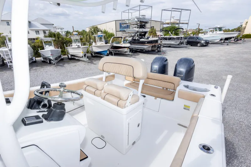 Slide: The Image of 2019 Sportsman Heritage 251 Center Console boat with dual engines in a marina setting. - 40