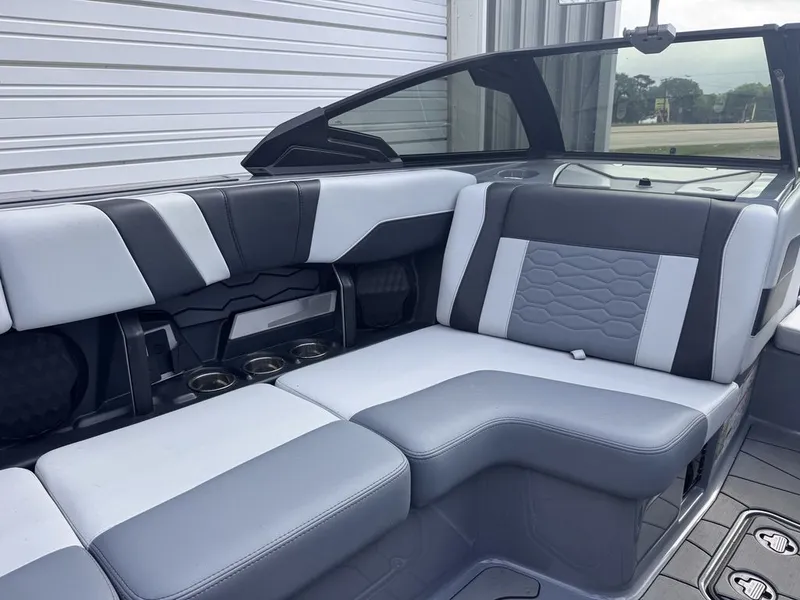 Slide: The Image of 2024 Malibu Wakesetter 23 MXZ interior with gray and white seating. - 14