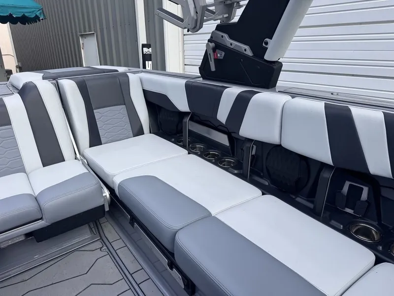 Slide: The Image of 2024 Malibu Wakesetter 23 MXZ interior with gray and white seating. - 16