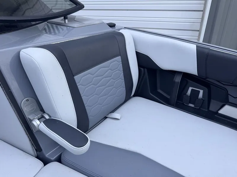 Slide: The Image of Interior of 2024 Malibu Wakesetter 23 MXZ with gray and black seating. - 23