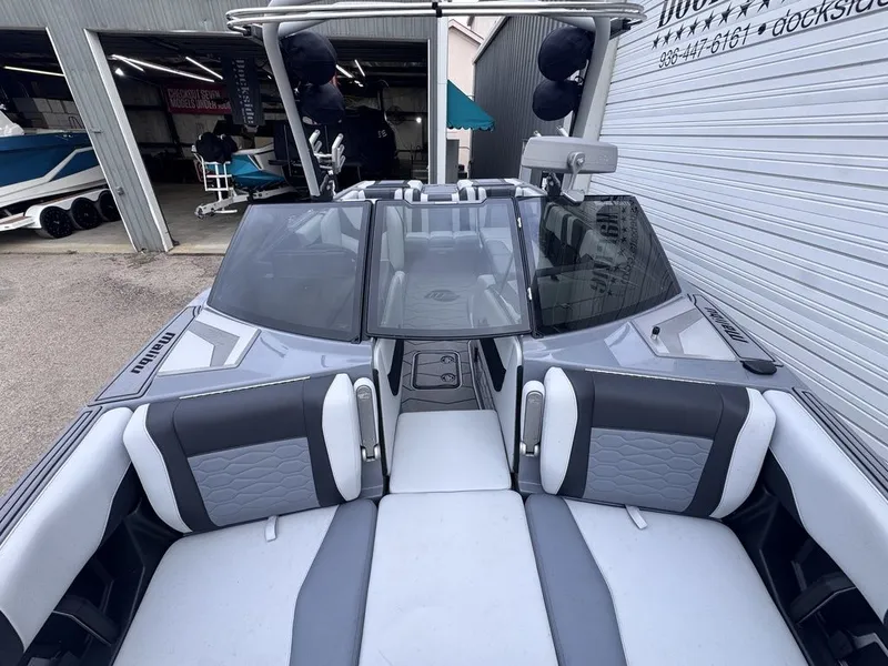 Slide: The Image of 2024 Malibu Wakesetter 23 MXZ boat interior with gray upholstery. - 24
