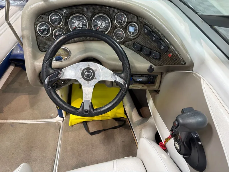 Slide: The Image of Interior of a 2011 Crownline 21 SS boat with dashboard and steering wheel. - 13