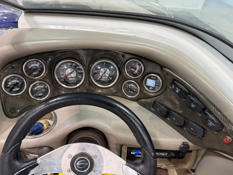 Slide: The Image of Dashboard of a 2011 Crownline 21 SS boat with gauges. - 14