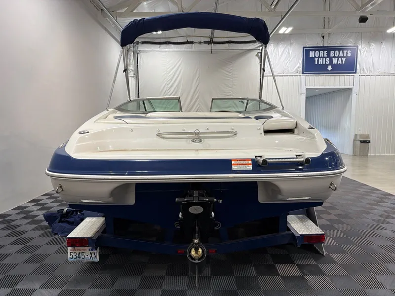 Slide: The Image of Rear view of a 2011 Crownline 21 SS boat in showroom. - 4