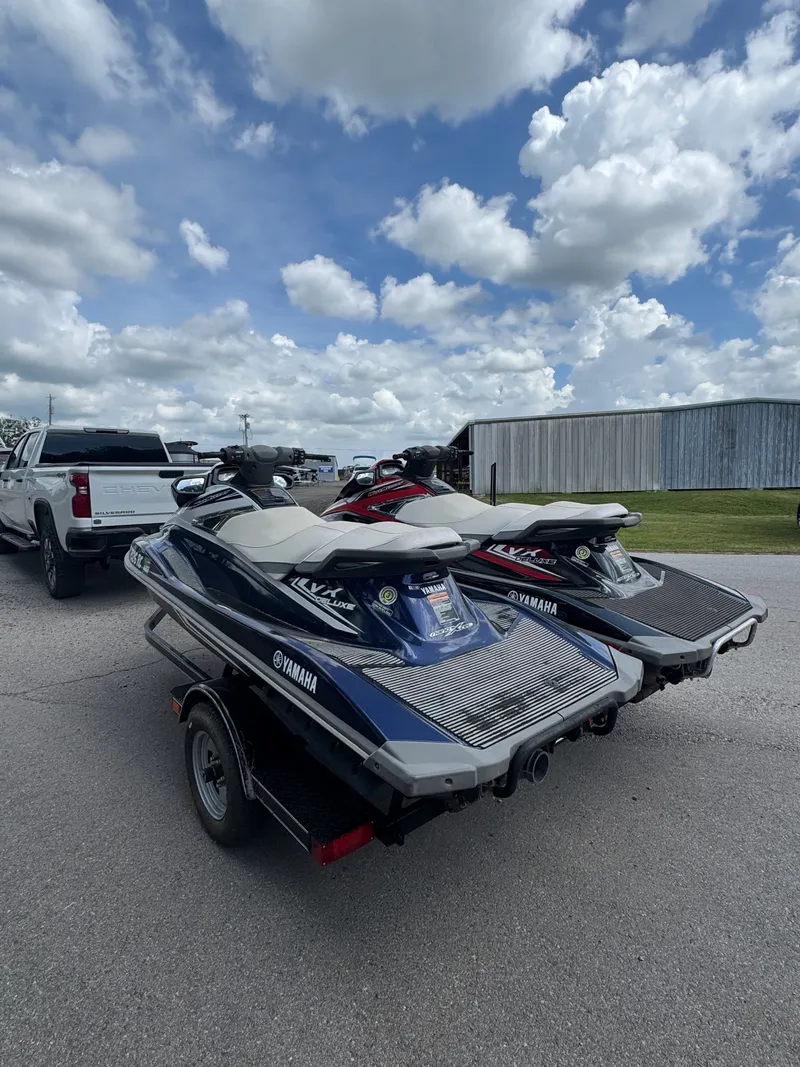Slide: The Image of 2016 Yamaha WAVERUNNER jet skis on trailer under cloudy sky. - 3