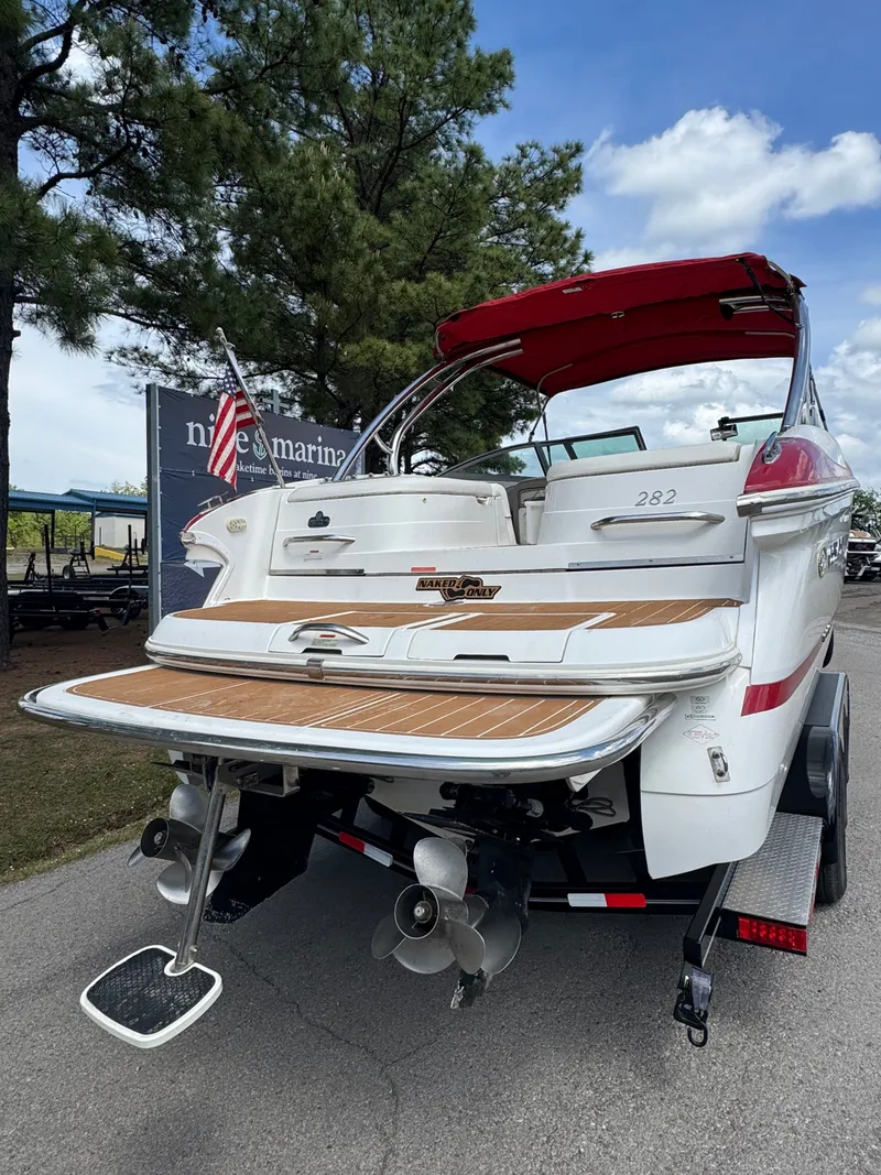Slide: The Image of 2003 Cobalt 282 boat with red canopy and American flag. - 3