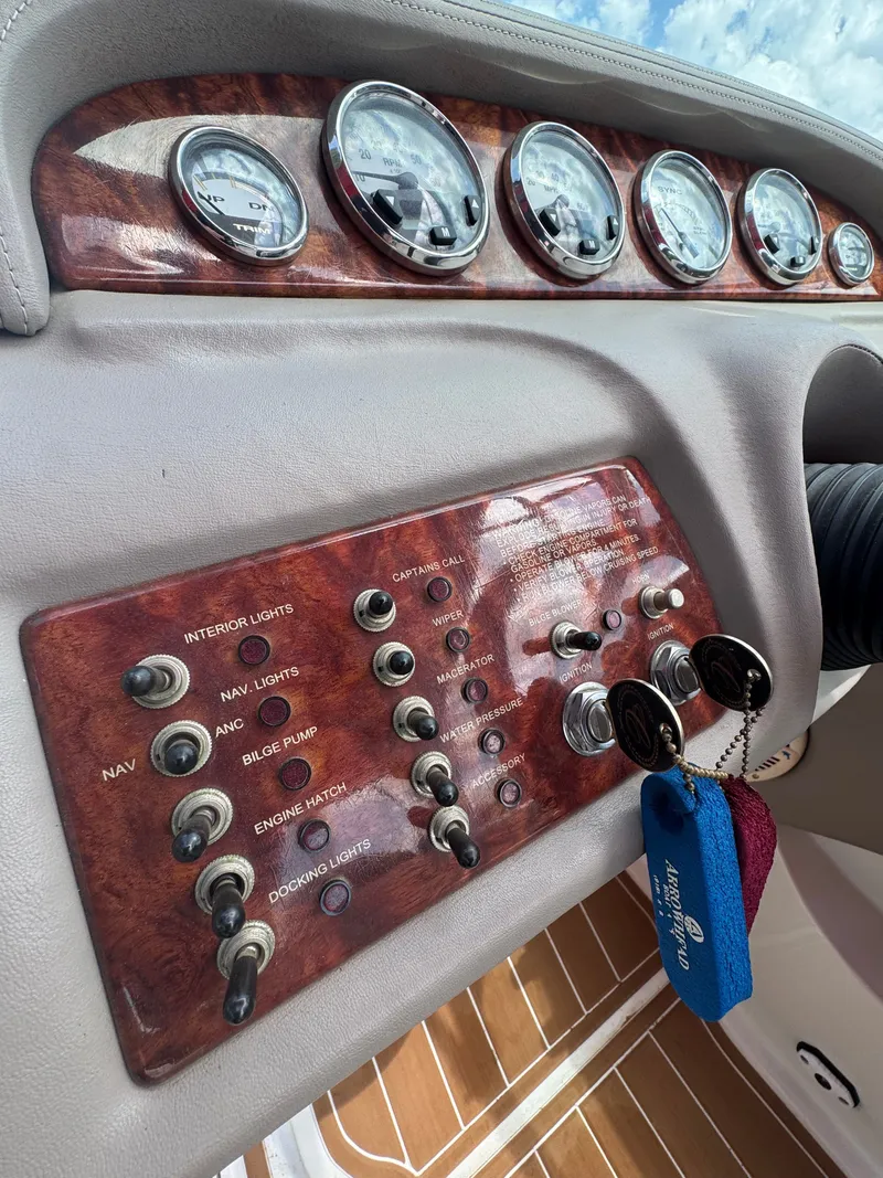 Slide: The Image of Dashboard of a 2003 Cobalt 282 boat with switches and gauges. - 7