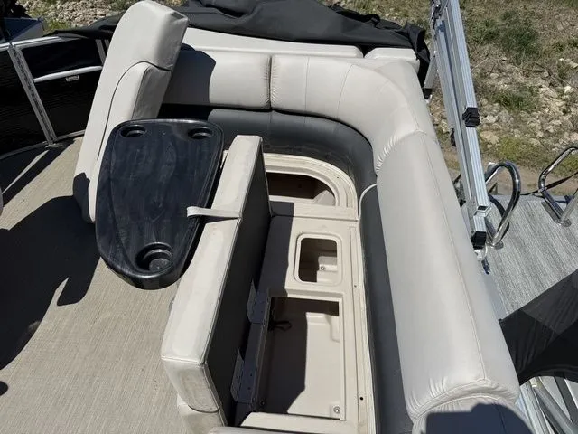 Slide: The Image of Interior of a 2017 Bennington 21SLX pontoon boat with seating area and table. - 18