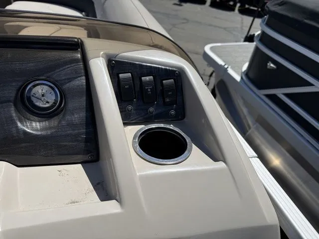 Slide: The Image of Dashboard of a 2017 Bennington 21SLX pontoon boat with switches and cup holder. - 15