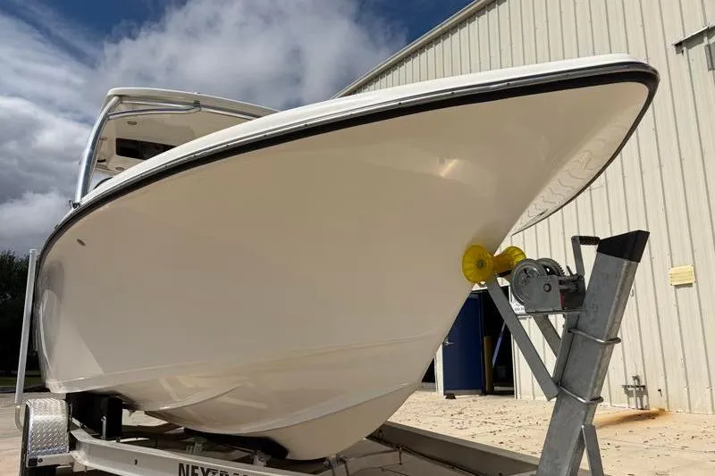 Slide: The Image of 2024 Key West 239 DFS boat with Yamaha 250 engine, parked outdoors. - 11