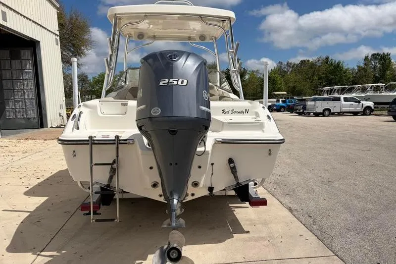 Slide: The Image of 2024 Key West 239 DFS boat, "Reel Serenity IV," with four-stroke engine, docked outdoors. - 13