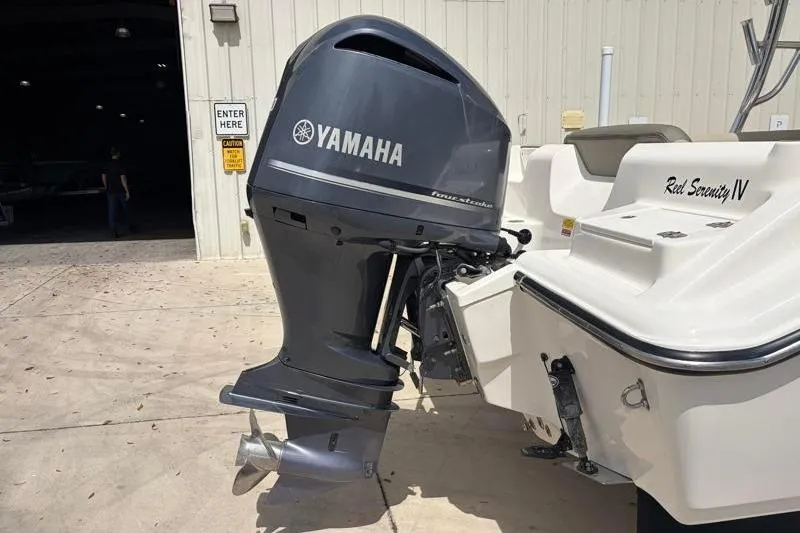 Slide: The Image of 2024 Key West 239 DFS boat interior with cushioned seating and cup holders. - 16