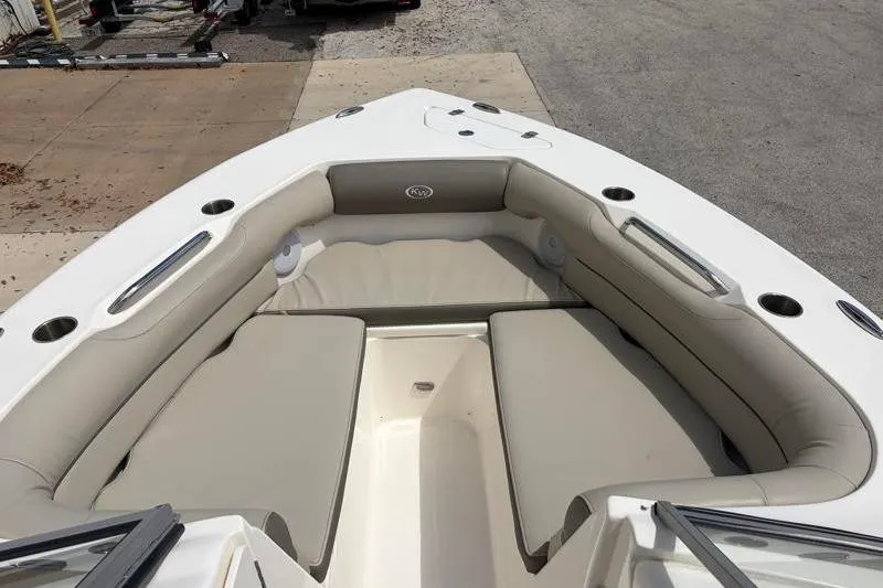 Slide: The Image of 2024 Key West 239 DFS boat interior with cushioned seating and cup holders. - 18