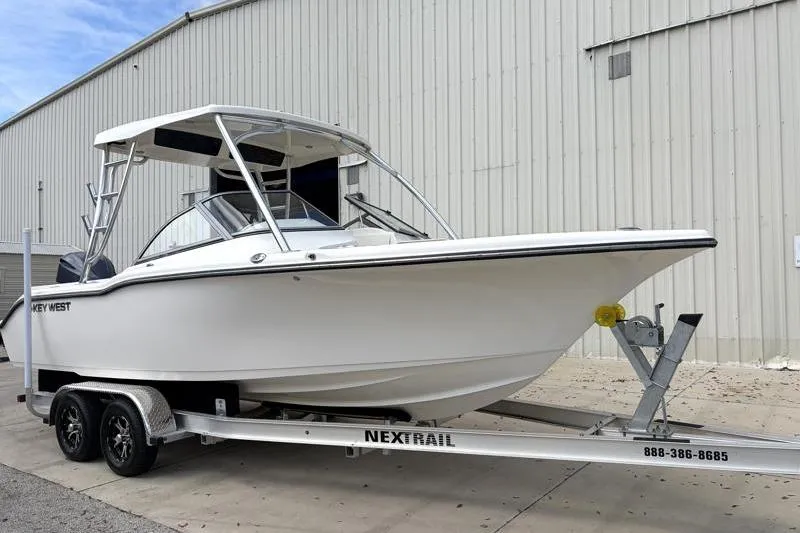 Slide: The Image of 2024 Key West 239 DFS boat on trailer with Yamaha outboard motor. - 2
