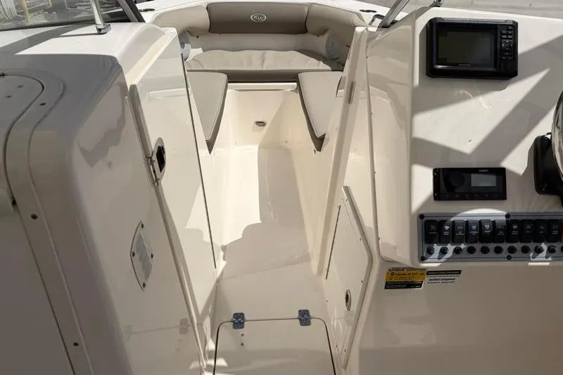 Slide: The Image of 2024 Key West 239 DFS boat dashboard with steering wheel and navigation controls. - 21