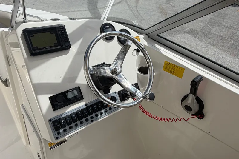 Slide: The Image of Control panel of 2024 Key West 239 DFS boat with switches and Fusion audio system. - 23