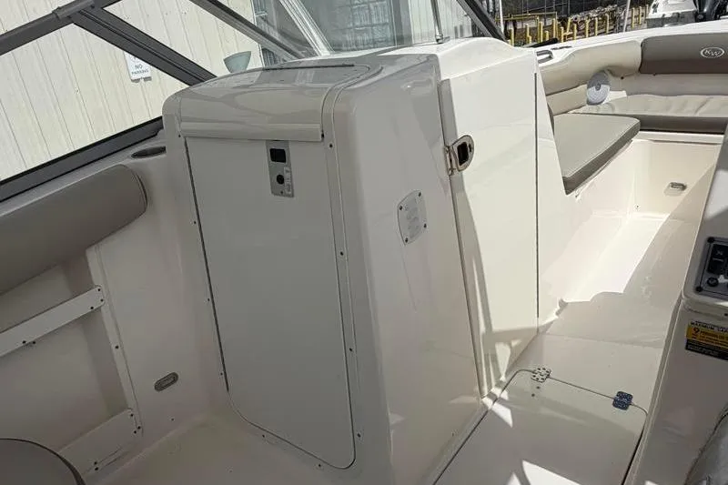Slide: The Image of 2024 Key West 239 DFS boat seating, featuring dual beige cushioned seats. - 28