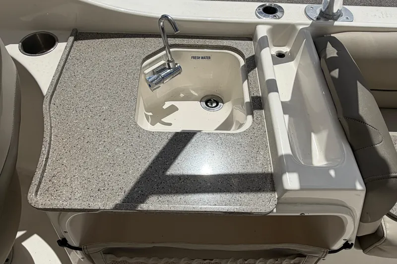 Slide: The Image of 2024 Key West 239 DFS boat interior with beige seating and cup holders. - 32