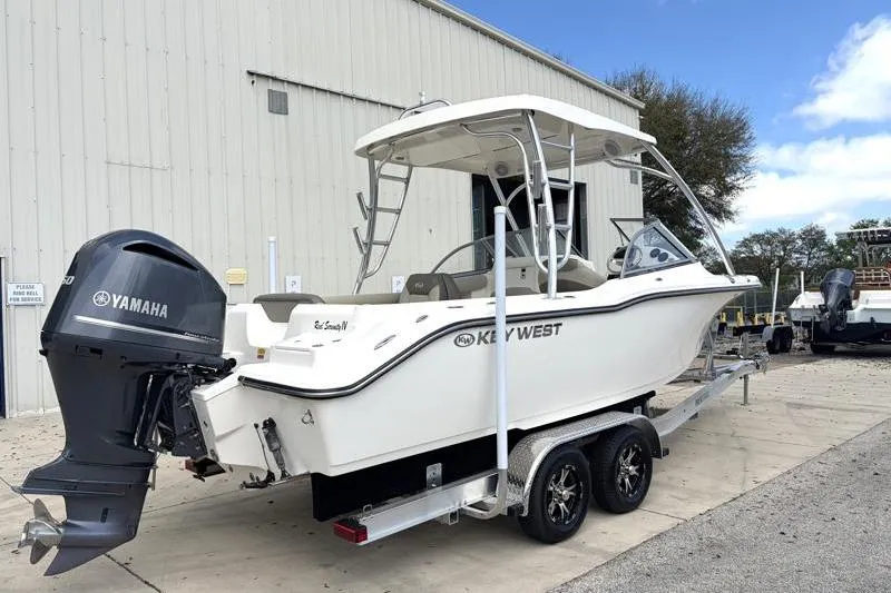Slide: The Image of 2024 Key West 239 DFS boat on trailer under cloudy sky. - 4
