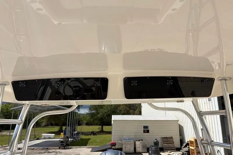 Slide: The Image of 2024 Key West 239 DFS boat on Nextrail trailer, parked on concrete surface. - 40