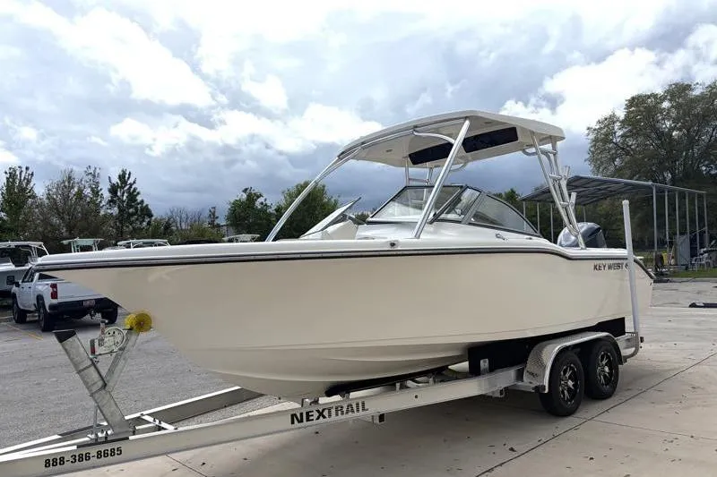 Slide: The Image of 2024 Key West 239 DFS boat on trailer with Yamaha outboard motor, parked outdoors. - 5