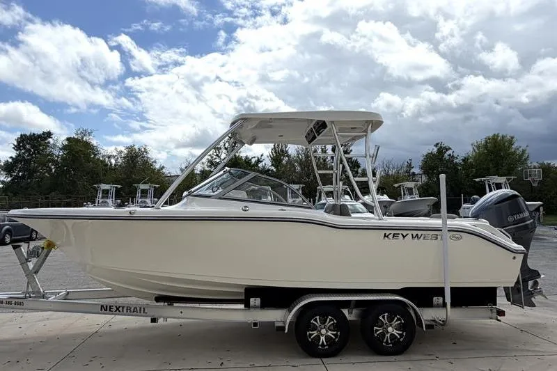 Slide: The Image of 2024 Key West 239 DFS boat on trailer, front view, outdoors near a building. - 6